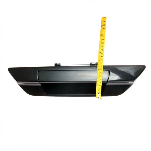 Black glossy plastic tail gate handle with integrated latch for Toyota Hilux Revo 2015-2023 shown from back side