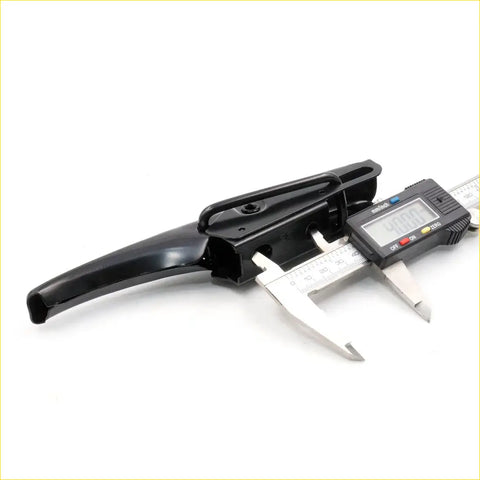 Black plastic tailgate lock handle with digital caliper measuring it for toyota hilux 1988-2004