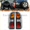 Pair of aftermarket tail light assembly for Nissan Patrol GU 2005-2016 with black housing and amber white red lenses