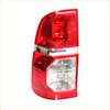 Red and clear plastic tail light light assembly with chrome trim for Toyota Hilux SR5 2011-2015, back side view