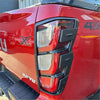 Red isuzu d-max 4x4 tail light back side with matte black taillight covers black trim and chrome accents 2024+