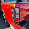 Red isuzu d-max 2024 pickup truck back side with matte black taillight covers and black trim accents