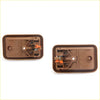 Tan bezel door handles for mazda bravo with brown plastic covers and orange internal mechanisms shown from back side