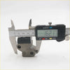 A black digital caliper measuring a gray metal tensioner guide chain for datsun nissan 620 j15 j16 1972-1979
