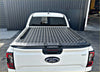 Black diamond plate aluminum bed liner on the back of white ford ranger xlt with tomahawk hardlid next gen 2022-current