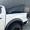 Black metal truck bed ramp with textured diamond plate and circular cutouts for tomahawk hardlid next gen ranger 2022-current
