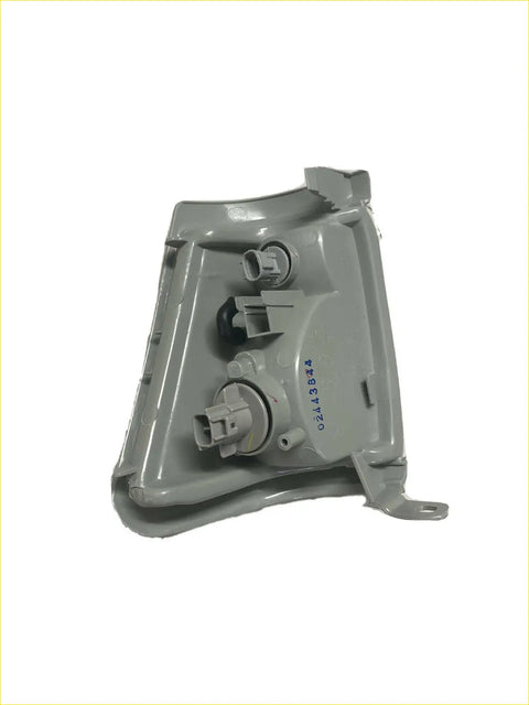Back side of gray plastic headlight housing with molded brackets and two electrical connectors for toyota hilux 1999-2001 indicator light right side