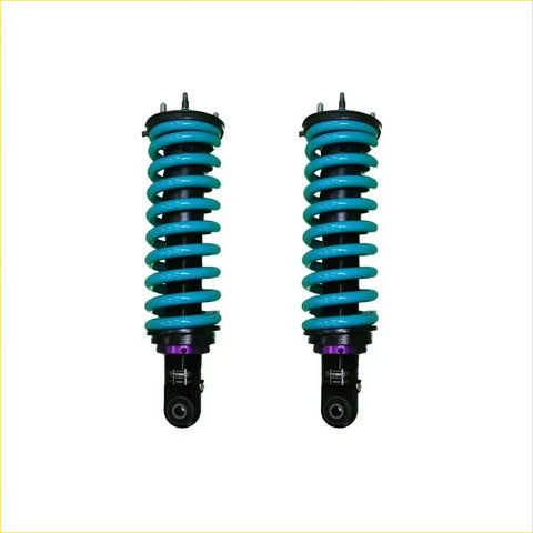 A pair of dobinsons ims monotube front shock absorbers for toyota hilux n70 with teal springs and purple accents