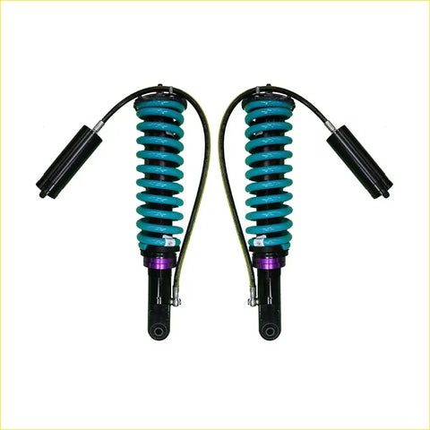 A pair of teal coiled dobinsons monotube suspension shocks with black and purple accents for toyota hilux n80 2015 onwards