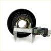 Black rubber transmission bearing with metallic inner parts and digital caliper showing 58.60 mm for nissan datsun 620 ute