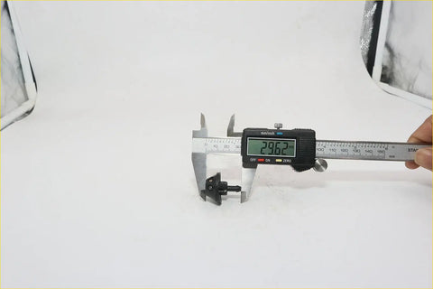 Black plastic carabiner being measured with digital caliper for window washer nozzle on nissan 720 navara sentra pathfinder datsun